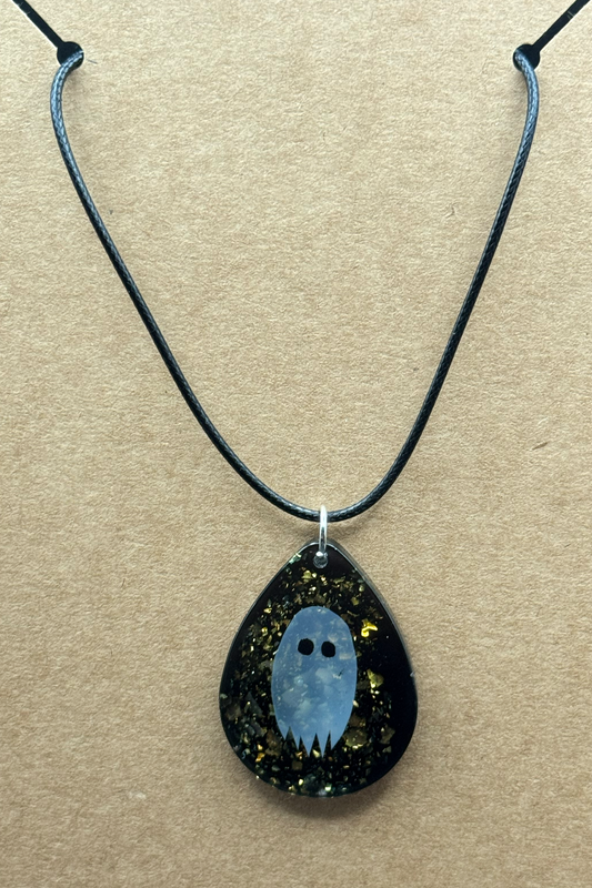 Necklace - A Teardrop Shaped Resin Charm Features A Paper Ghost Floating on A Sparkly Black Background